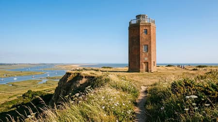 Historic brick Naze Tower standing on the coastal cliff-top greensward at Walton-on-the-Naze, Essex.